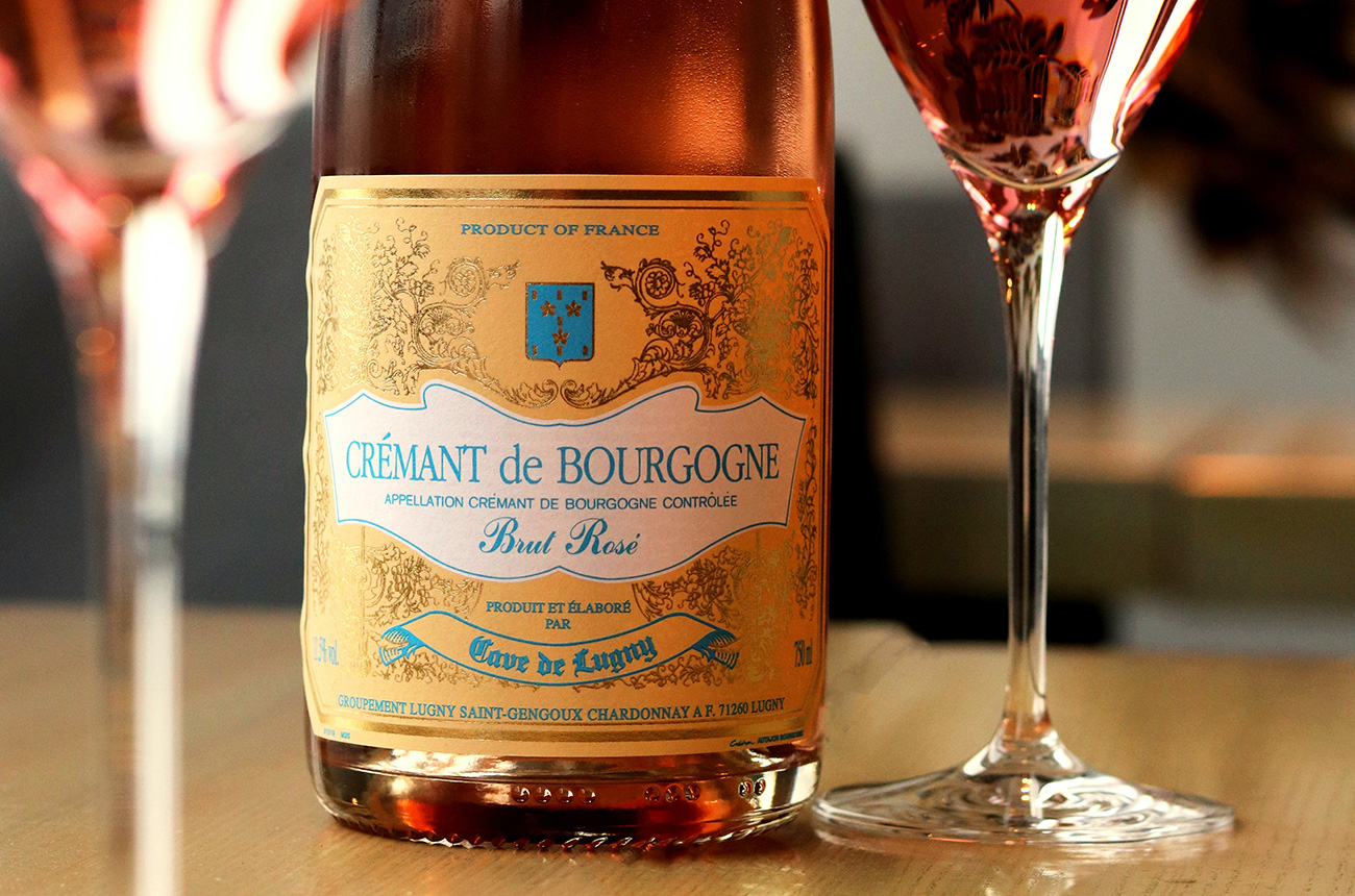 A flute being filled with sparkling wine with bubbles rising quickly